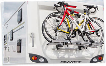 2 Bikes mounted to a Thule Cycle carrier on the rear wall of a Swift touring caravan