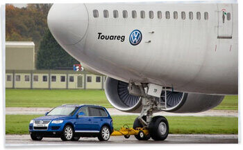 VW Touareg towing an aeroplane