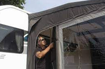 a man zipping up a awning panel
